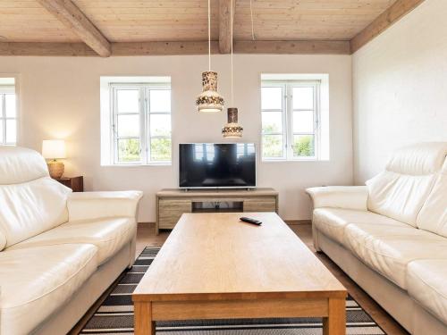 a living room with two white couches and a tv at 6 person holiday home in Faaborg-By Traum in Fåborg