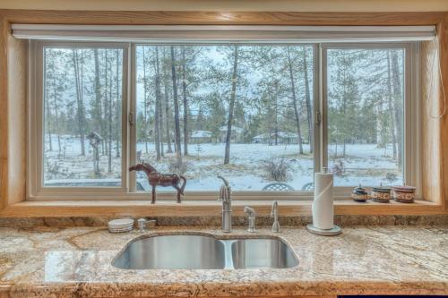 a kitchen sink with a horse statue in a window at Mugho 10 - Meredith Lodging in Sunriver