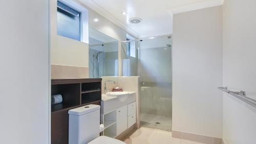 a bathroom with a toilet and a sink at Ohana Beach House in Tangalooma