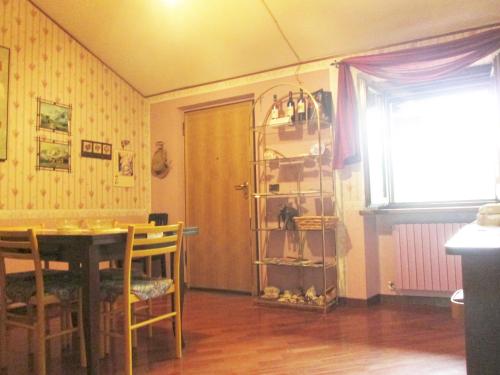 a dining room with a table and a room with a window at B&B Piceno in Castel di Lama