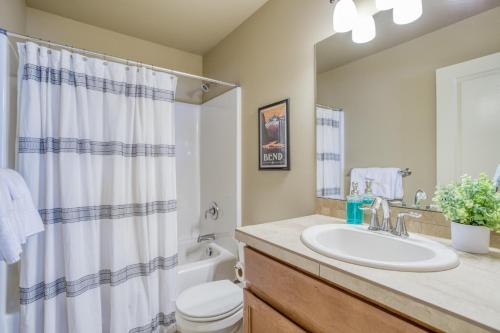 a bathroom with a sink and a toilet and a shower at East Bend Beauty in Bend