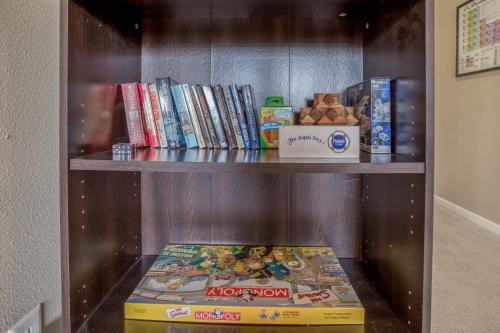 a book shelf with a box of wii games at Hunters Circle - Meredith Lodging in Bend