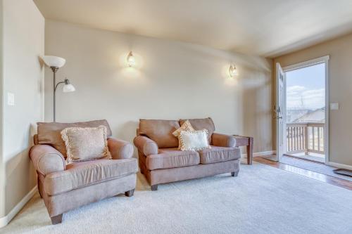 a living room with two chairs and a window at Hunters Circle - Meredith Lodging in Bend