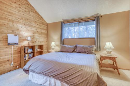 a bedroom with a large bed and a window at Owls Nest - Meredith Lodging in Sunriver