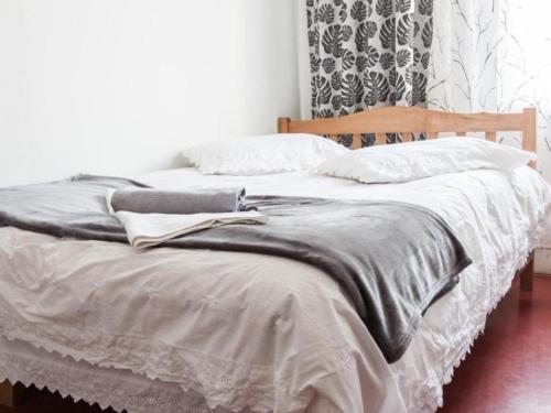 a bed with a blanket and pillows on it at Veriko's Guest Hause in Kazbegi