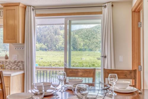 a dining room with a table and a large window at Riverfront Gem - Meredith Lodging in Cloverdale