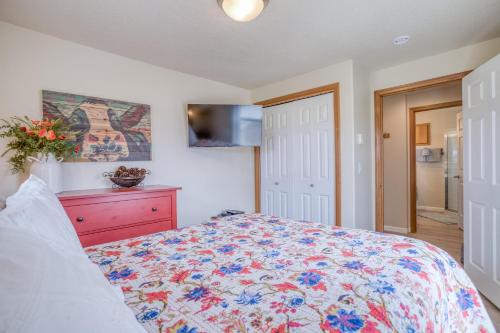 a bedroom with a bed with a floral bedspread at Riverfront Gem - Meredith Lodging in Cloverdale