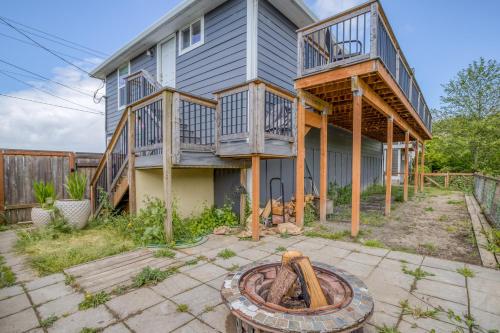 a large house with a deck and a patio at Riverfront Gem - Meredith Lodging in Cloverdale