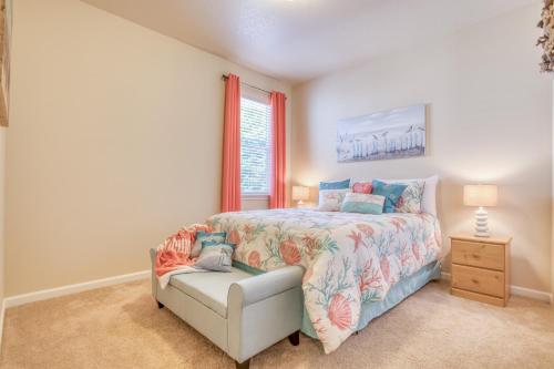 a bedroom with a bed and a chair and a window at Herons Perch - Meredith Lodging in Netarts