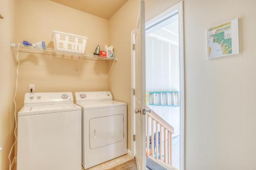 a laundry room with a washer and dryer at Herons Perch - Meredith Lodging in Netarts