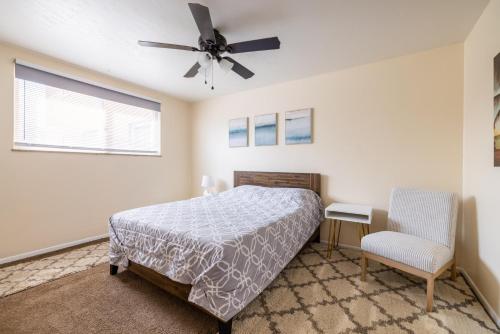 a bedroom with a bed and a ceiling fan at Georgetown Villas 2-1b Ideal for long stays! in Fairview Park
