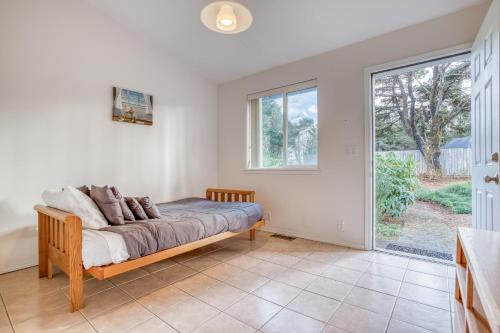 a bedroom with a bed and a large window at Beverly Beach Seaclusion in Newport