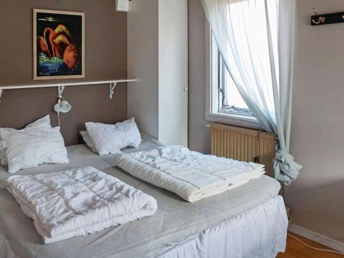 two twin beds in a room with a window at 3 person holiday home in TROSA-By Traum in Trosa