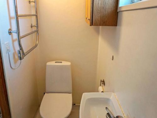 a small bathroom with a toilet and a sink at Holiday home TROSA in Trosa