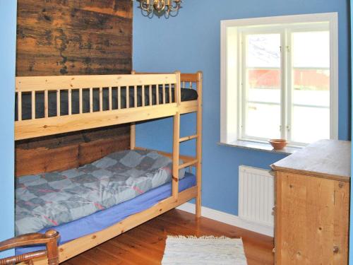 a bedroom with a bunk bed and a window at Holiday home VANKIVA in Vankiva