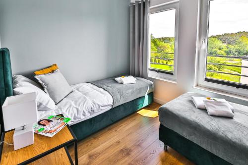 Postel nebo postele na pokoji v ubytování Klif Resort Apartamenty