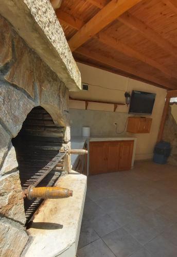 a large stone oven in a kitchen with a tv at Guesthouse Iceberg in Ravda
