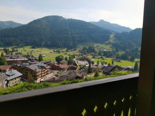 a view from a balcony of a town with mountains at Studio avec vue splendide sur les Diablerets in Les Diablerets