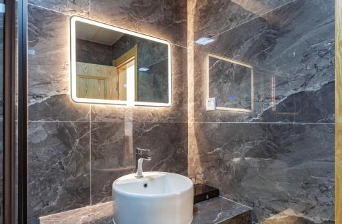 a bathroom with a sink and a mirror at ManBuYunDuan.Theme Inn in Wutai