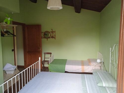 a bedroom with a bed and a green wall at Casa LEPRICE in SantʼElpidio a Mare