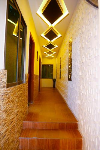 a hallway with stairs in a building with lights at New Taj Hotel in Lahore