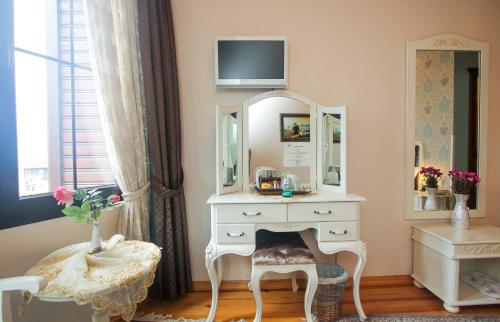 a small room with a dresser, mirror, and a dresser at Esans Hotel - Special Category in Istanbul