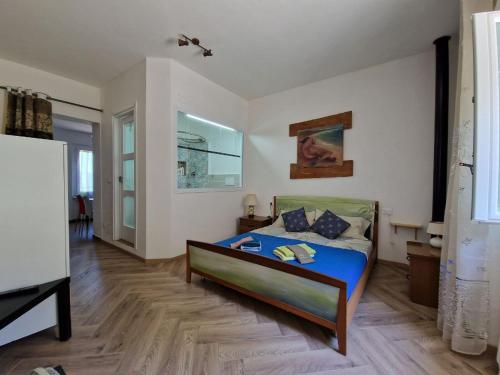 a bedroom with a bed and a tv in it at VETULONIA ROMANTICA in Vetulonia