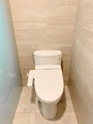 a bathroom with a white toilet in a stall at 如沐咖啡旅宿 in Xingjian