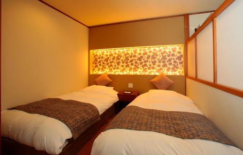Postel nebo postele na pokoji v ubytování Itsuura Kanko Hotel