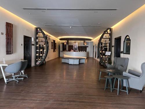 a store with chairs and tables in a room at Mutrah Hotel in Muscat