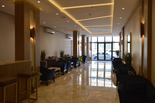 a lobby with a waiting room with chairs and a car at Terrace View Serviced Apartments 2 in Al Khobar