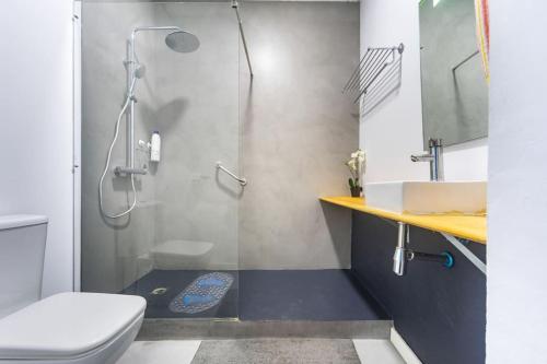 a bathroom with a shower and a toilet and a sink at 120 sqm Loft-style Apartment Beach Royal Marina in Valencia