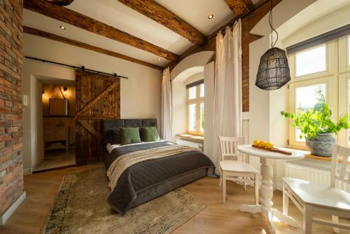 a bedroom with a bed and a table and chairs at PropertiesForYou in Bielsko-Biała