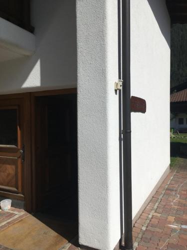 a door to a garage with a brick floor at Ferienwohnung Brandtner in Waidring
