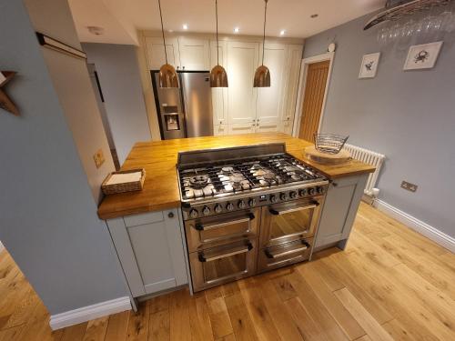 a kitchen with a stainless steel stove top oven at Neet Retreat - sleeps 7 next to beach in Bude
