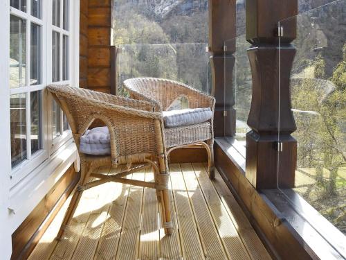 a wicker chair sitting on the porch of a house at 9 person holiday home in Geiranger-By Traum in Geiranger