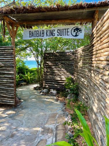 a building with a sign that reads backyard king suite at Rock and Sea Resort in Watamu
