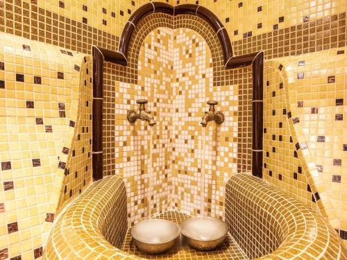 a bathroom with two toilets in a tiled shower at Kamengrad Hotel & SPA in Panagyurishte