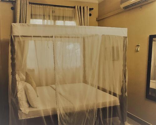 a swing in a room with a curtain at Transit Airport B&B in Dar es Salaam