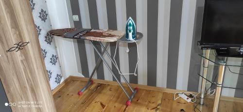 a small table in a room with a television at Qabala Villa House Samir in Gabala