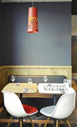 a dining room with a table and two chairs at ibis Birmingham Airport Terminal Building - NEC in Bickenhill