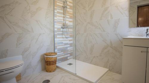 a bathroom with a shower and a toilet and a sink at Villa Pedro - Swimming Pool - BY BEDZY in Albufeira