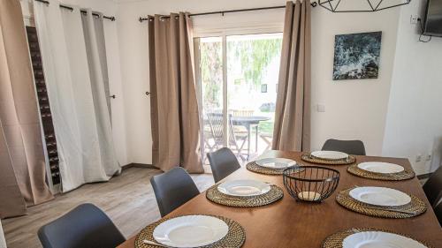 a dining room with a table and chairs and a window at Villa Pedro - Swimming Pool - BY BEDZY in Albufeira