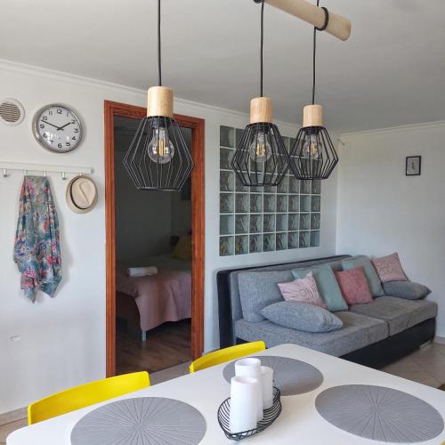 a living room with a couch and a table at Panorama Wine & Chill in Hévíz