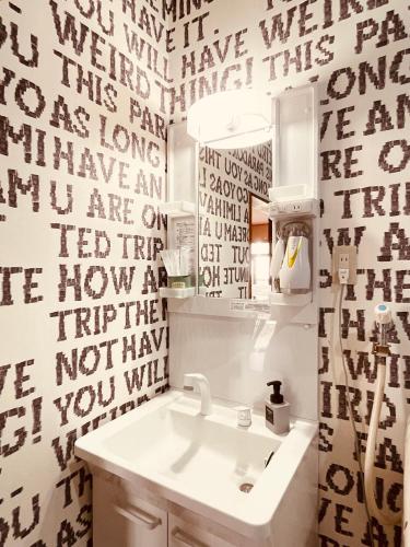 a bathroom with a sink and a mirror at SAMURISE DARUMA in Fujiyoshida