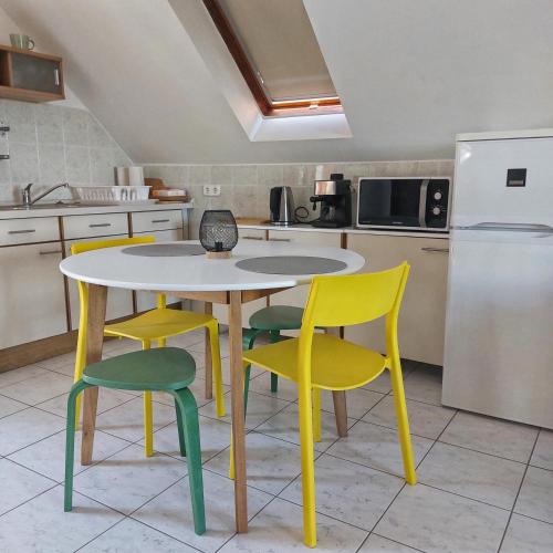 a kitchen with a table and four chairs at Panorama Wine & Chill in Hévíz
