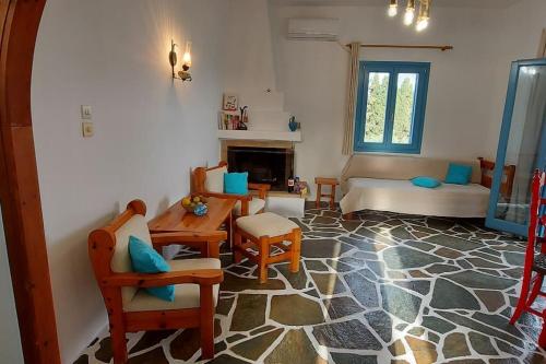 a living room with a couch and a table and chairs at Villa Stevi in Drios