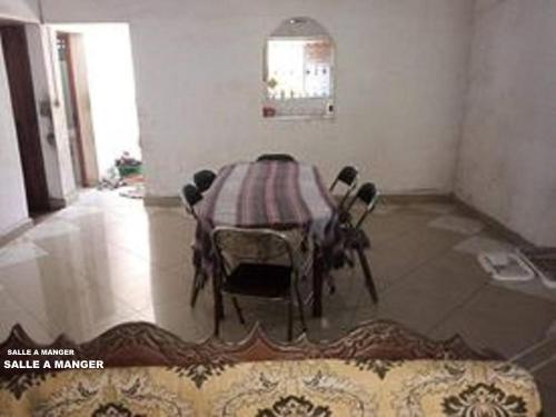 a table in a room with a table and chairs at TAMATAVE Chez Bien Aimée in Toamasina