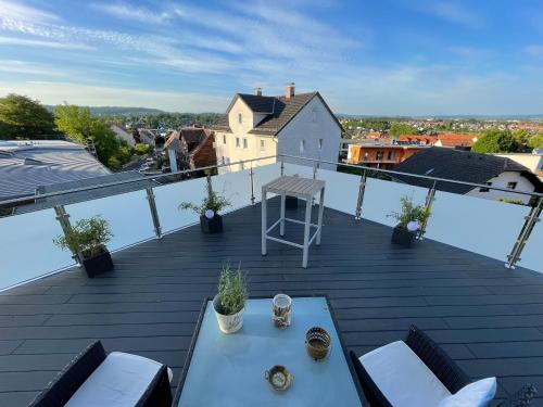 a balcony with a table and chairs on a roof at Hotel Zum Berggarten in Kassel