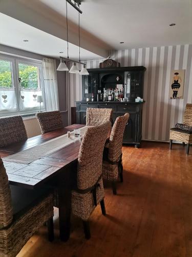 a dining room with a wooden table and chairs at Gästehaus Reiterlodge auf dem Land 